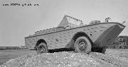 Amphibious Sea Jeep for Allied Fighters find the going to its liking as it goes over a hump on the test track. It can take knocks just as well as its landlubber brother.