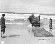 Jeep landing on beach with the help of early chain link fence type Landing Mat